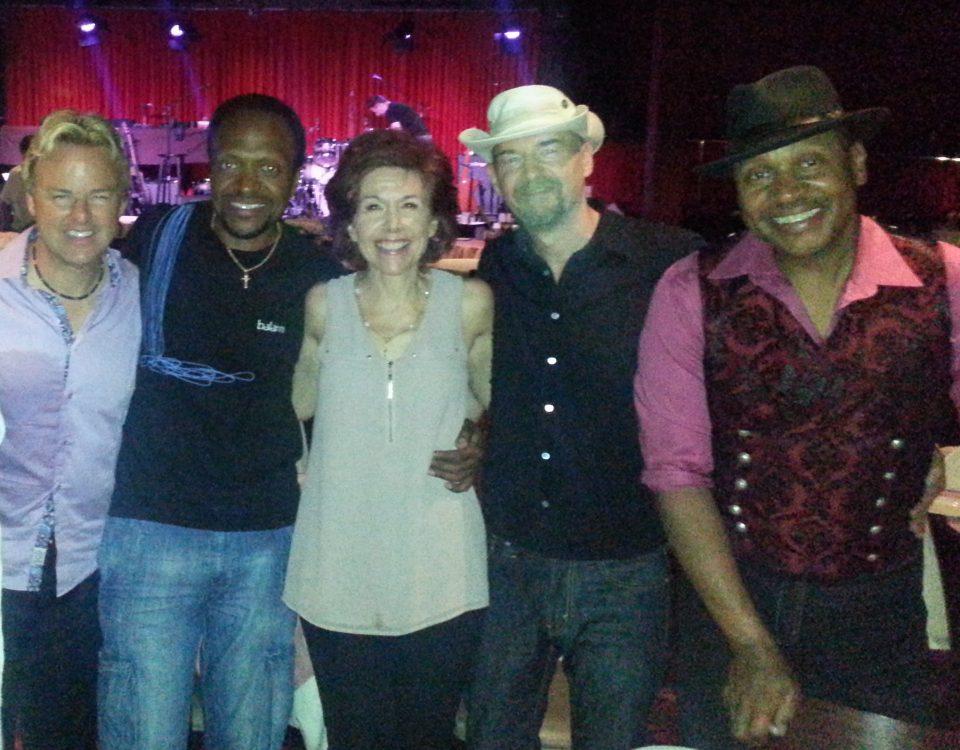 Anita Finlay with a group of men featured in the "Jazz Greats Acoustic Alchemy Inspire Art for Its Own Sake" blog.