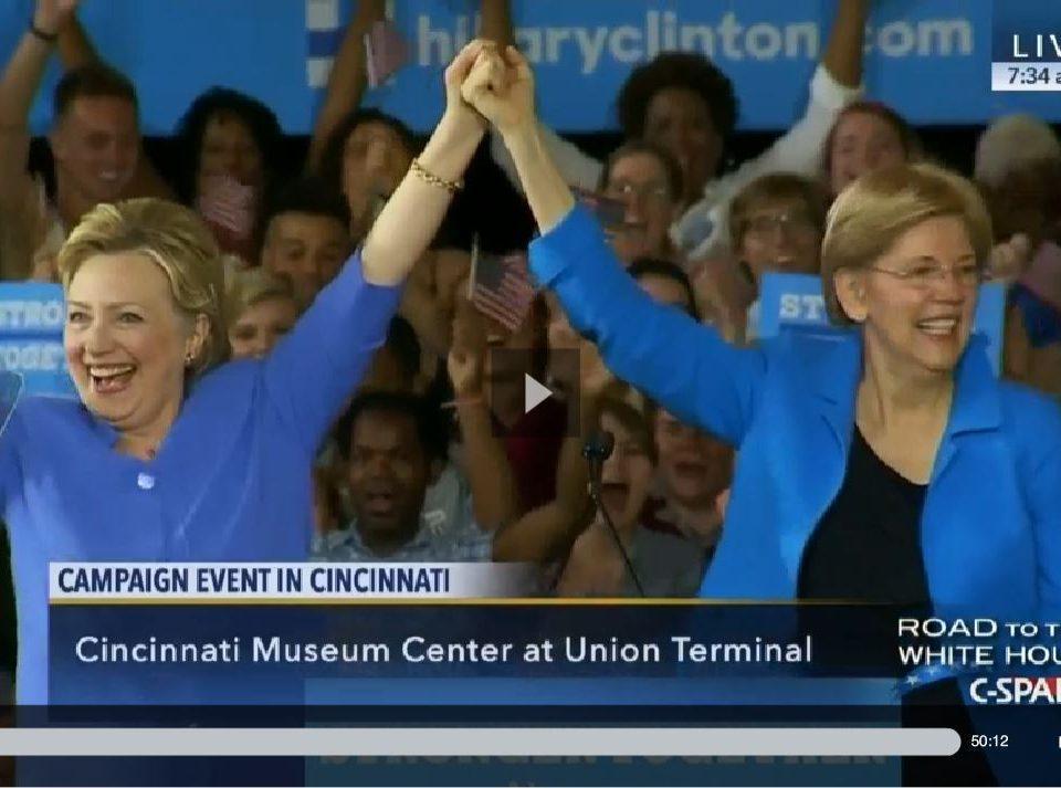 Hillary Clinton and Elizabeth Warren holding raised hands featured in the "Elizabeth Warren’s Passion for Hillary’s Candidacy Renders Bernie Irrelevant" blog.
